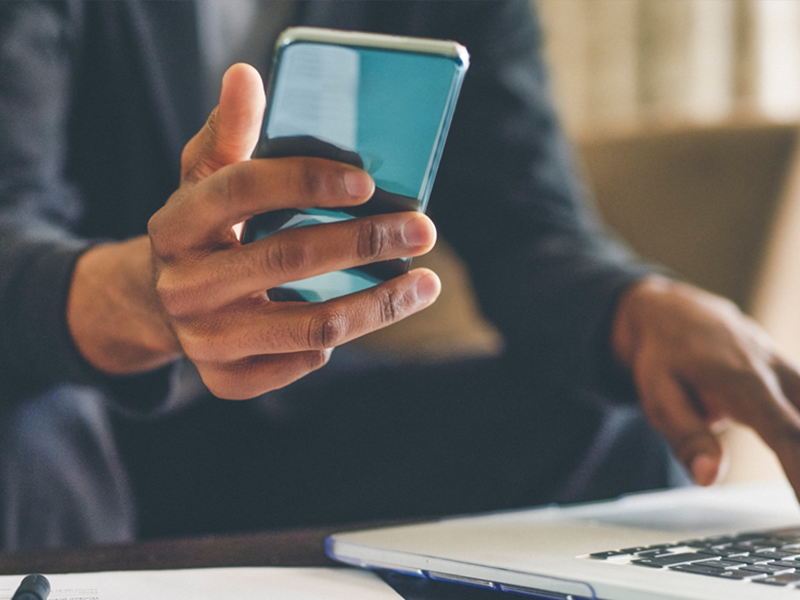 Technology - Man using phone & laptop