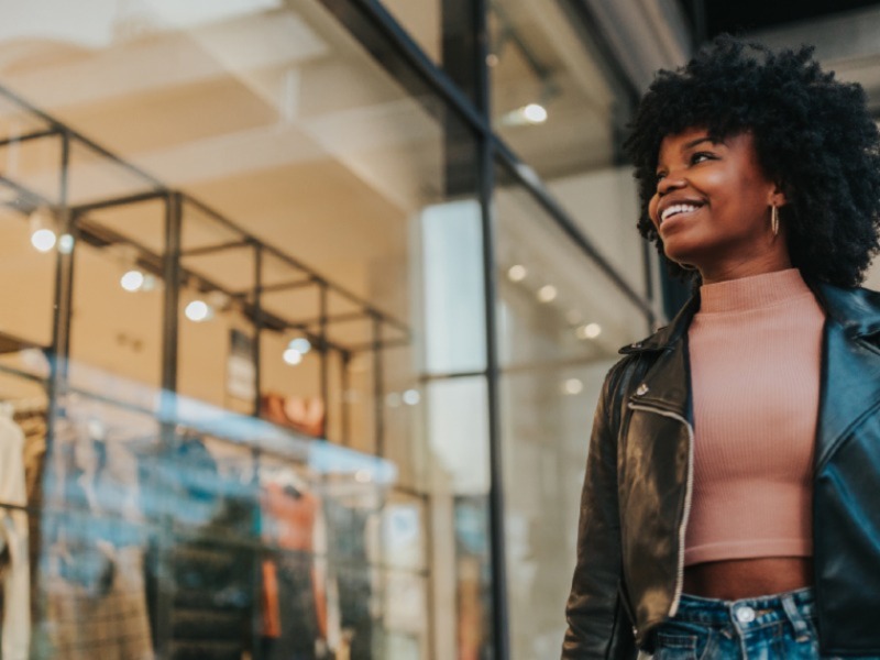 Retail - lady smiling and looking at shop