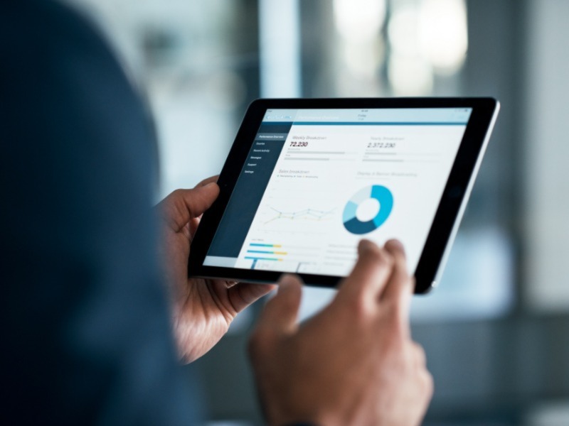 Businessman analyzing statistics on a digital tablet