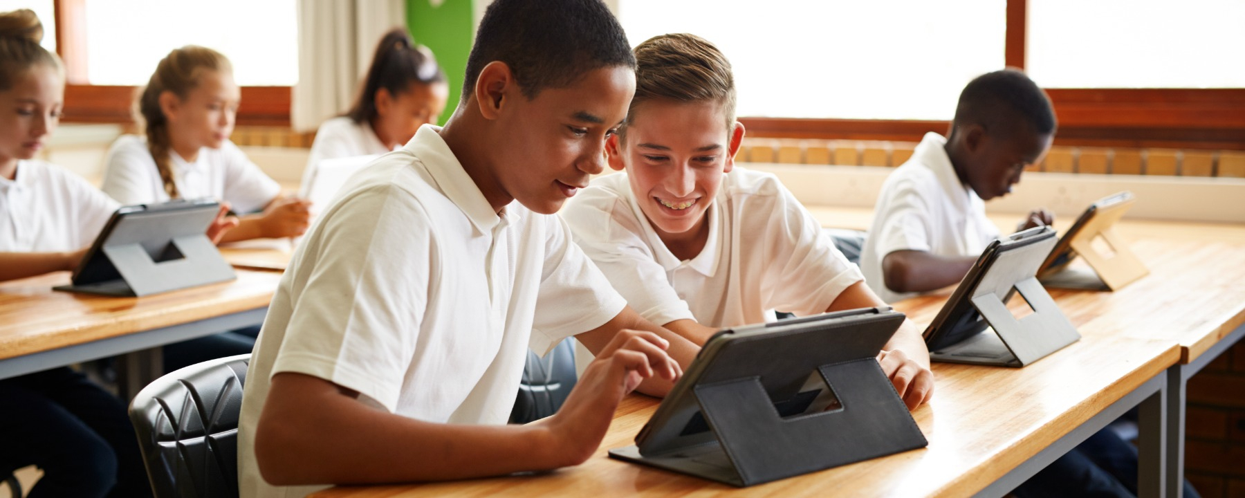 Education-Students using tablet in school classroom-548929077