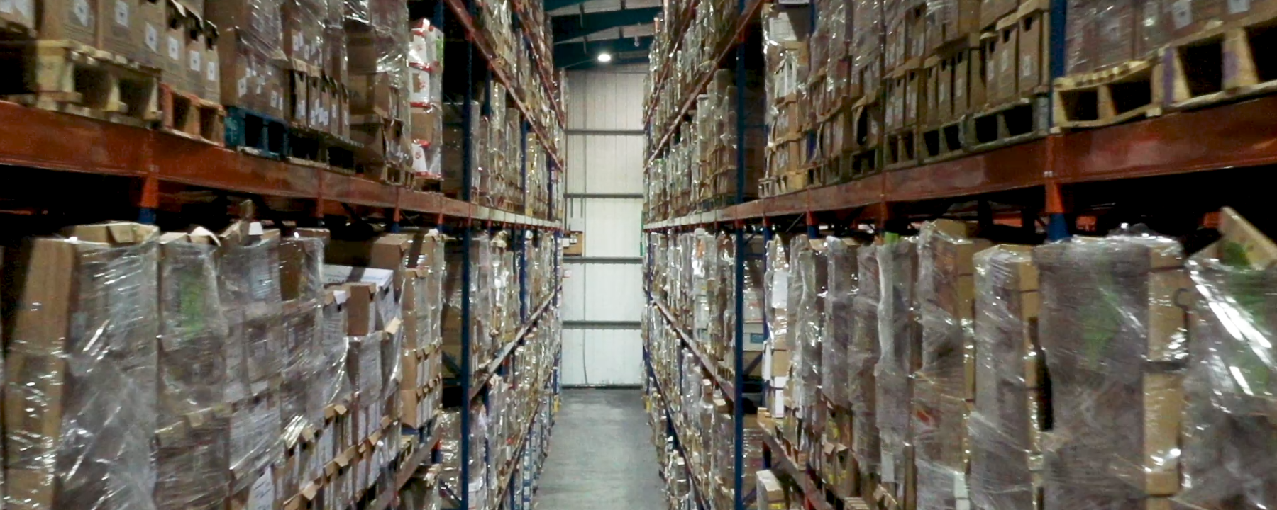 Warehouse aisle full of packages on pallet racks