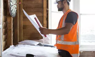 Construction worker looking at plans