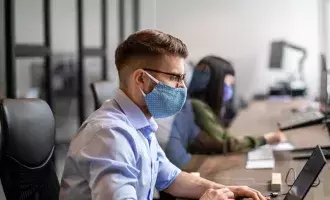 Office employees with masks social distancing