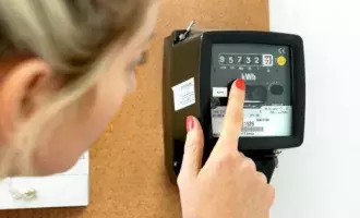 Utilities-Woman reading electric meter-166676218