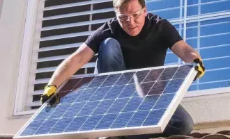 Utilities-Man installing solar panels