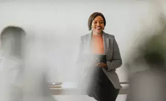 Confident Businesswoman Leading Group Meeting