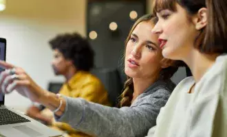 Women discussing screen