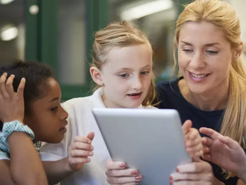 Children looking at tablet device