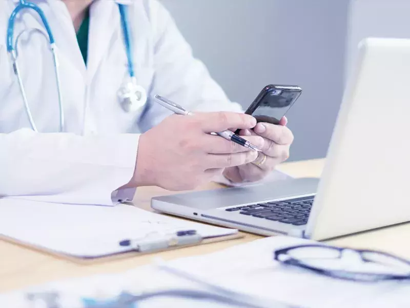 Healthcare professional holding mobile