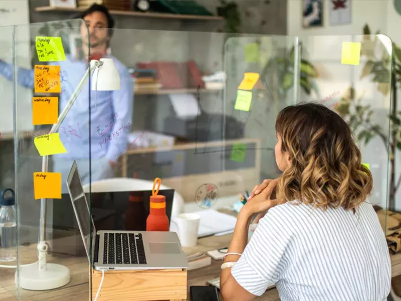 People looking at post it notes