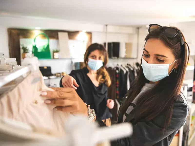 Women shopping wearing masks