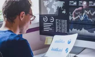 Man looking at data on a computer screen