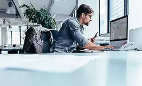 Business man in office looking at computer