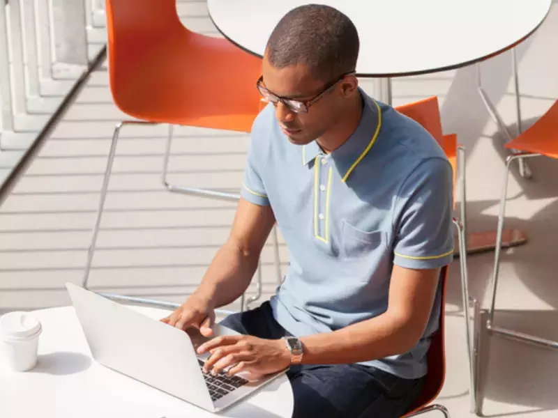 Student working on laptop outside