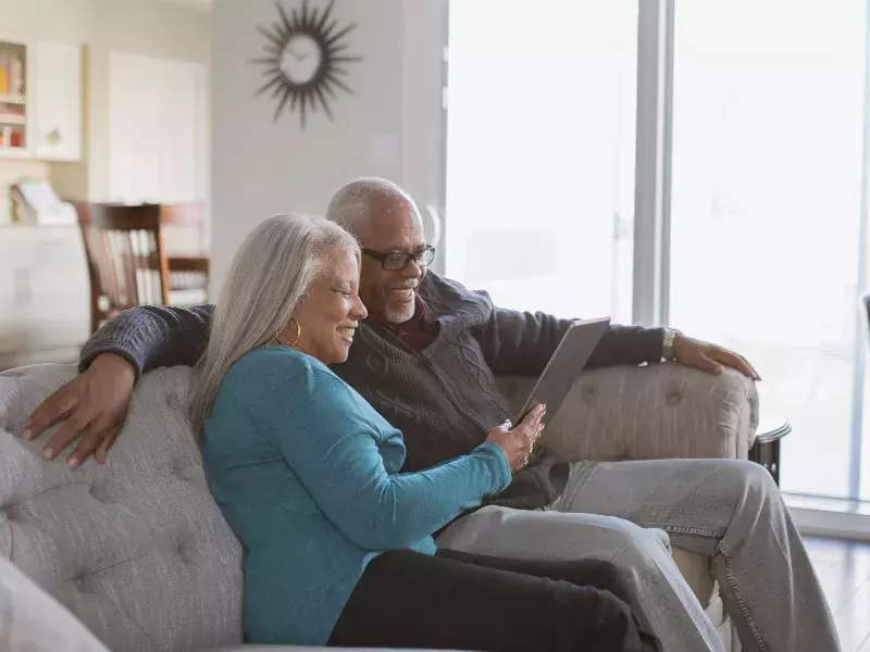 senor couple  looking at tablet