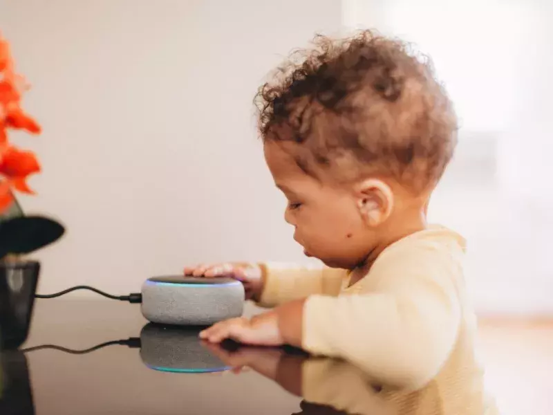 kid playing with electronic device