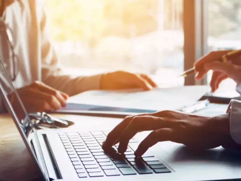 person using laptop at office