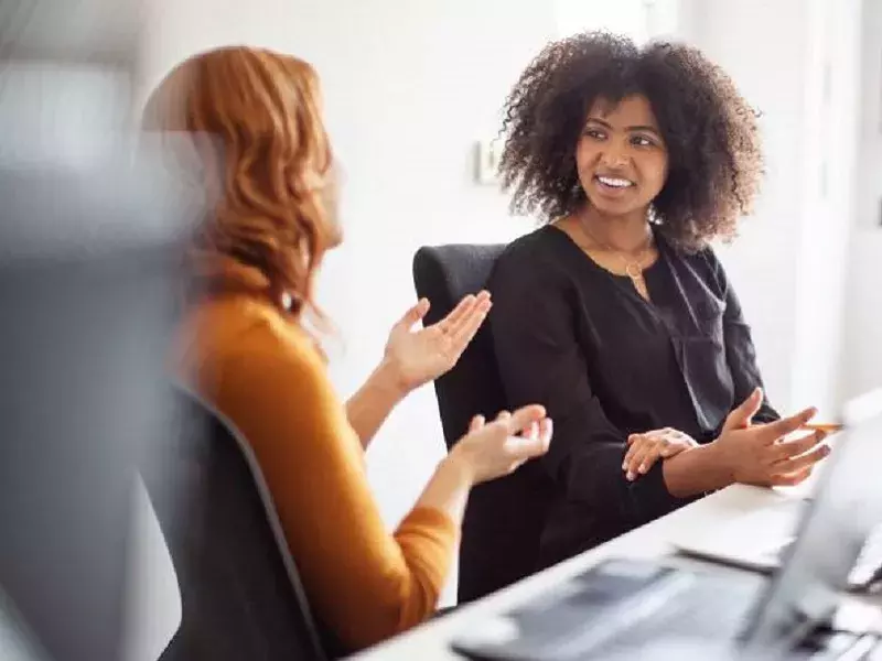 Capita careers Learning & Development 2 women talking in the office