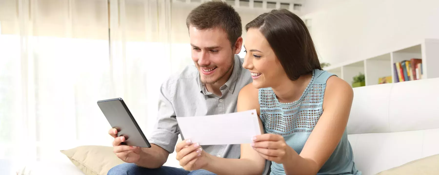 Young couple working together on a digital tablet