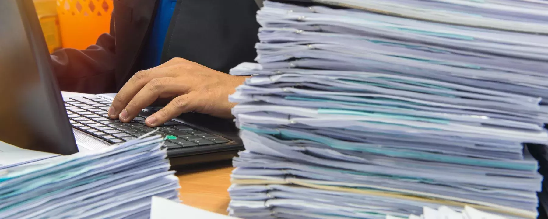 Businessman working with a laptop and documents on his desk 