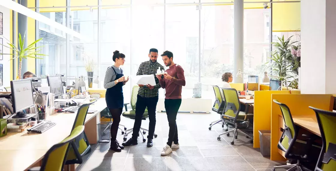 Colleagues discussing project in office