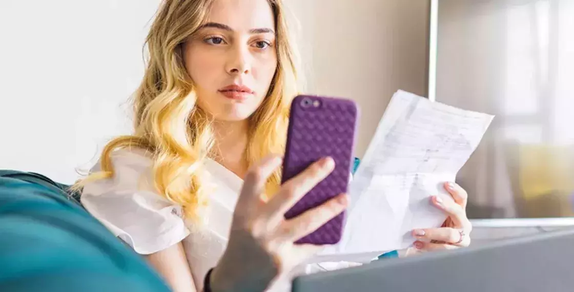 Girl paying bill using phone