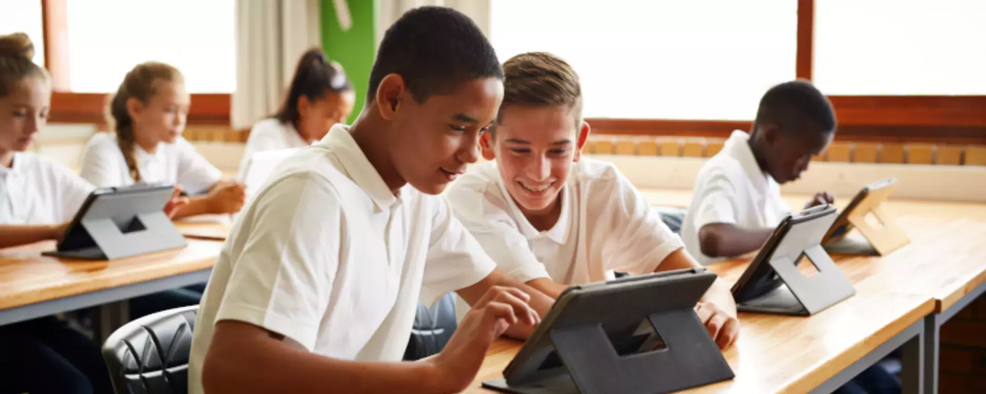 Students using tablet in school classroom