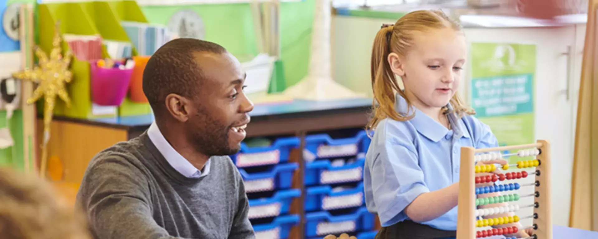 Student and children making maths fun